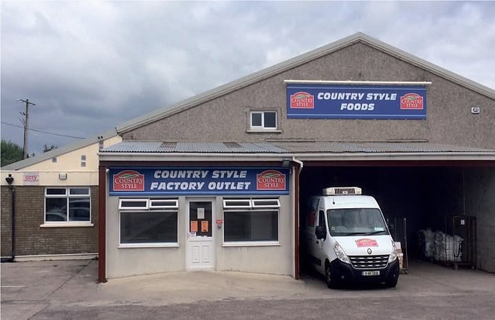 The Country Style Foods building seen from the road, with a van outside